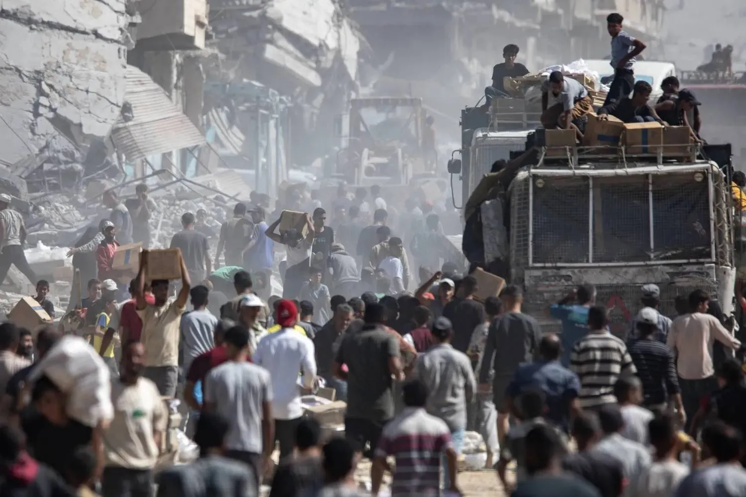 Palestinians gather around trucks carrying humanitarian aid upon their arrival in Khan Younis, southern Gaza Strip, on Saturday (EPA). 