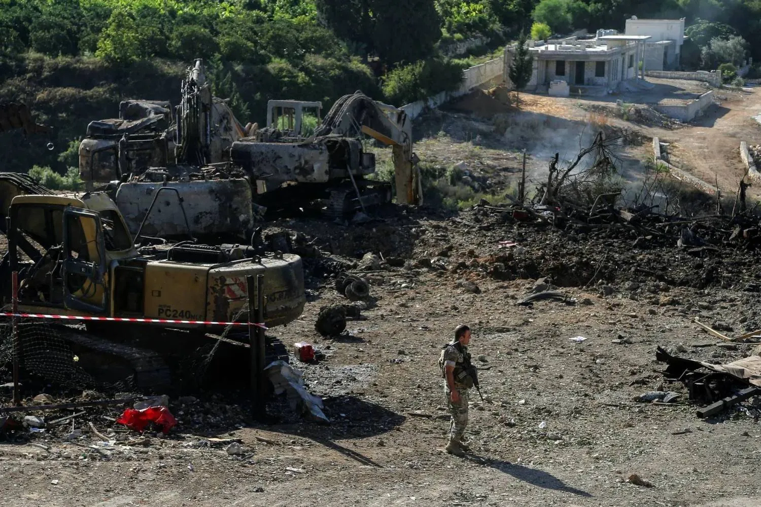 A Lebanese Army soldier at the site of an Israeli strike on bulldozer dealerships in southern Lebanon (DPA) 