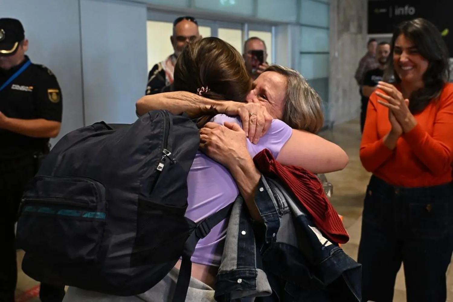 Mas Madrid MP Jimena Gonzalez (R) is welcomed by her mother upon her arrival, along with other Spanish activists from the Thousands Madleens Flotilla detained by Israeli forces, at Terminal T1 of Adolfo Suarez Madrid-Barajas Airport in Madrid, central Spain, 11 October 2025. (EPA)