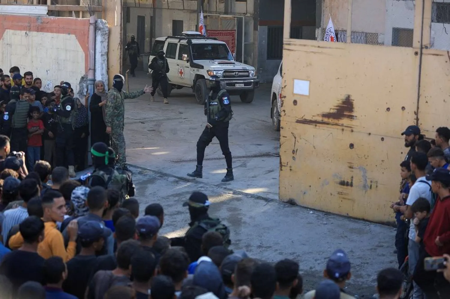 Hamas fighters keep guard as Red Cross vehicles transport hostages, held in Gaza since the deadly October 7, 2023 attack, following their handover as part of a ceasefire and hostages-prisoners swap deal between Hamas and Israel, in Gaza City October 13, 2025. (Reuters)
