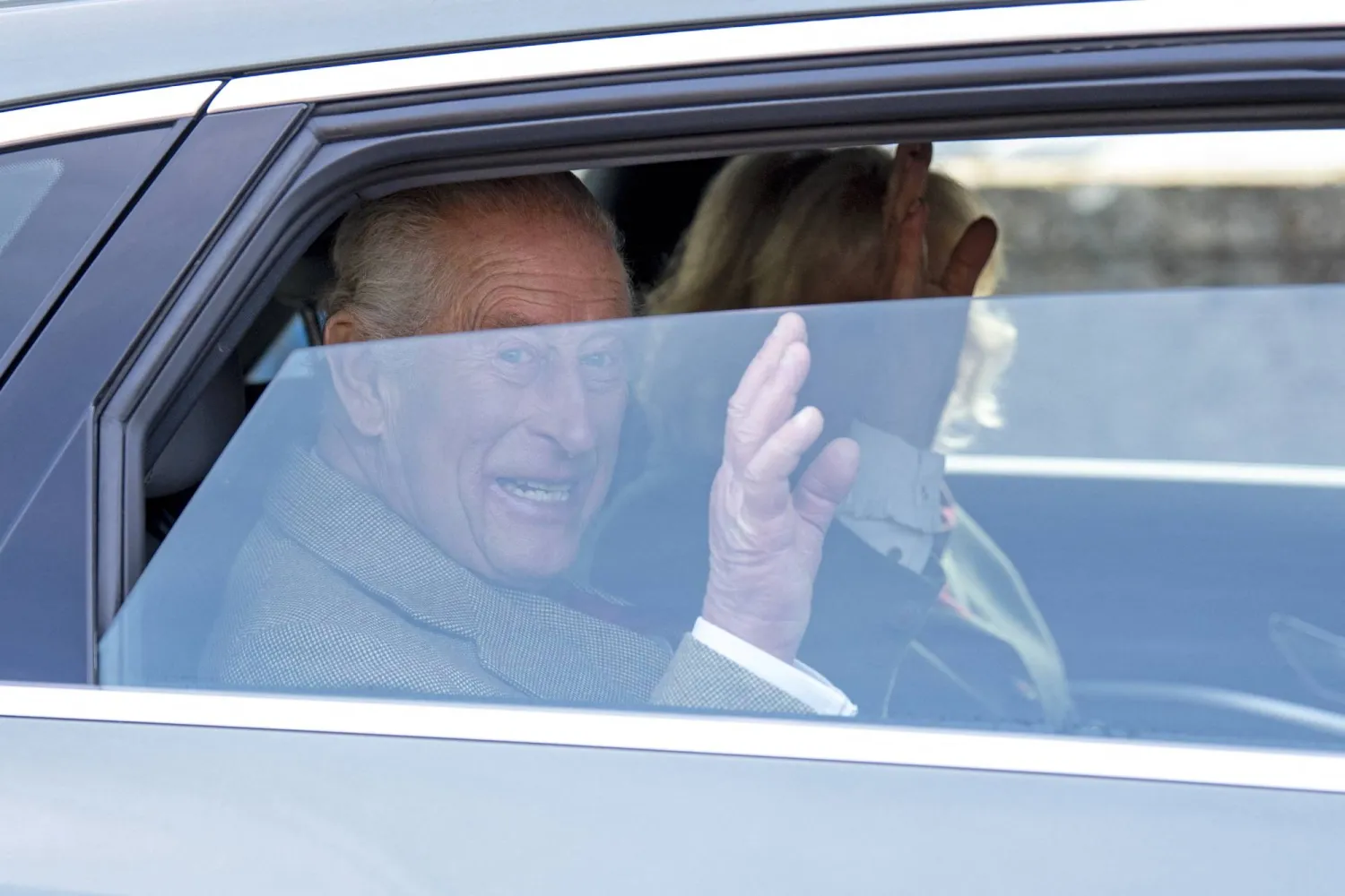 Britain's King Charles and Queen Camilla wave from a car during a visit to mark the 150th anniversary of the Albert Hall in Ballater, Scotland, Britain, October 9, 2025. Jane Barlow/Pool via REUTERS