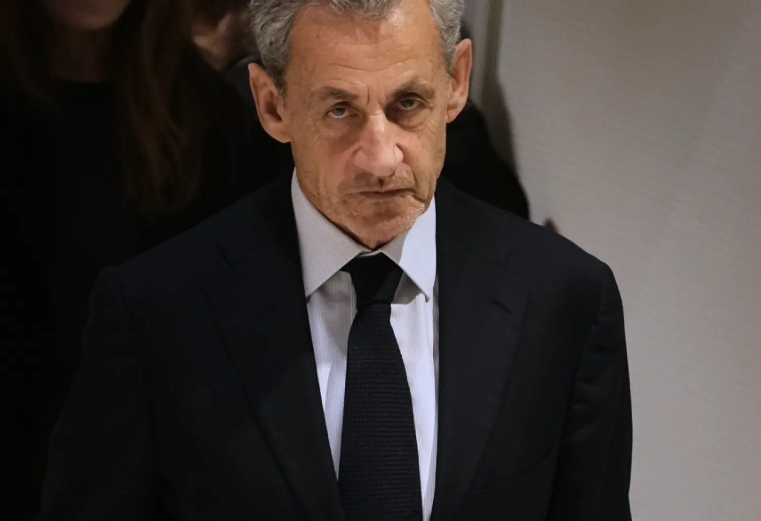 FILE- Former French President Nicolas Sarkozy leaves after a Paris court sentenced him to 5 years after finding him guilty of criminal conspiracy in an alleged scheme to finance his 2007 campaign with funds from Libya, Thursday, Sept. 25, 2025 in Paris. (AP Photo/Christophe Ena, File)