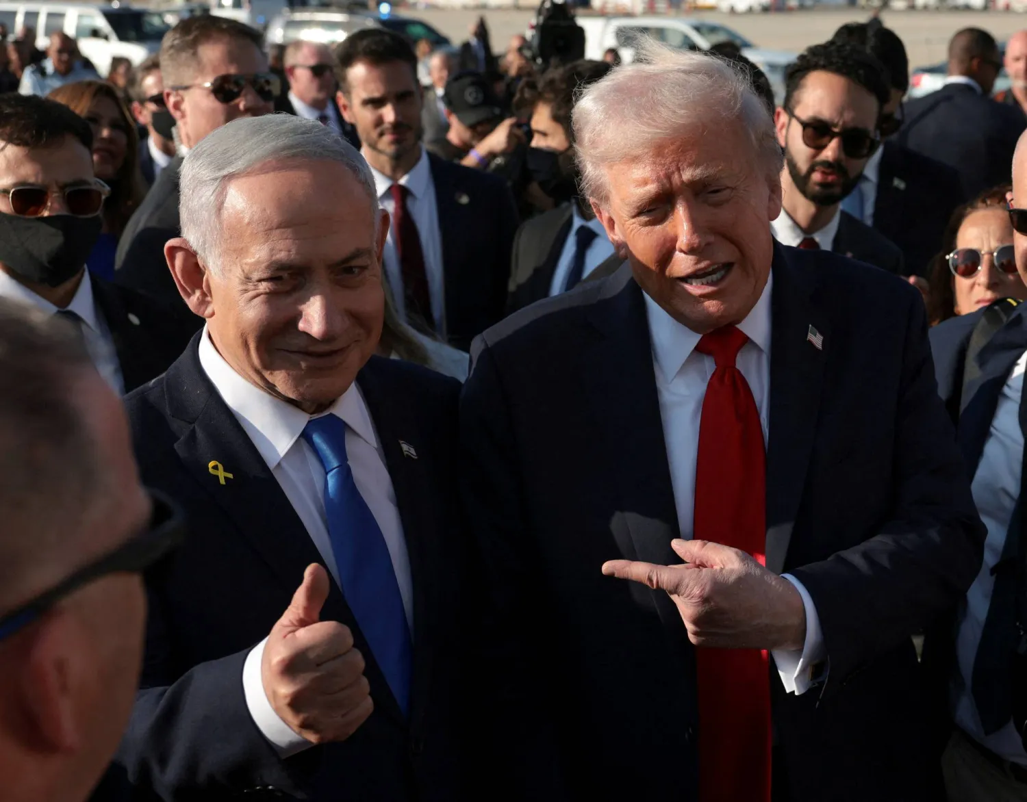 US President Donald Trump gestures next to Israeli Prime Minister Benjamin Netanyahu at Ben Gurion International Airport as Trump leaves Israel en route to Sharm el-Sheikh, Egypt, to attend a world leaders' summit on ending the Gaza war, amid a US-brokered prisoner-hostage swap and ceasefire deal between Israel and Hamas, in Lod, Israel, October 13, 2025. (Reuters)