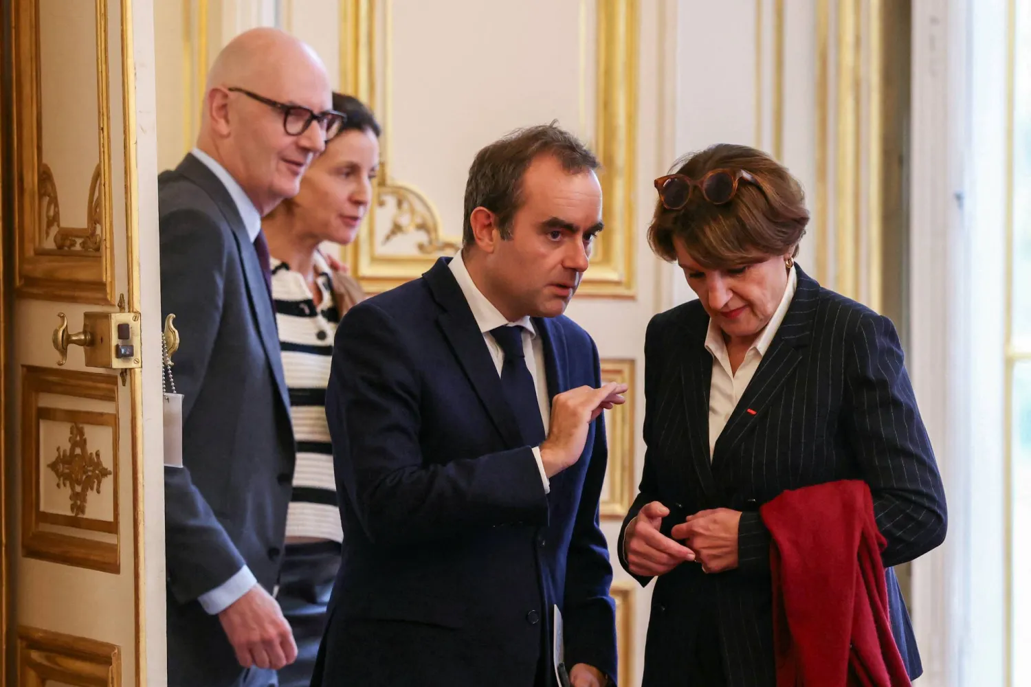 France's reappointed Prime Minister Sebastien Lecornu gestures next to France's Minister for Agriculture and Food Sovereignty Annie Genevard and France's Minister for Economy, Finances and Industrial and Digital Sovereignty Roland Lescure as he welcomes the newly-appointed members of his cabinet for a meeting, at the Hotel Matignon in Paris, France, October 13, 2025.  ALAIN JOCARD/Pool via REUTERS