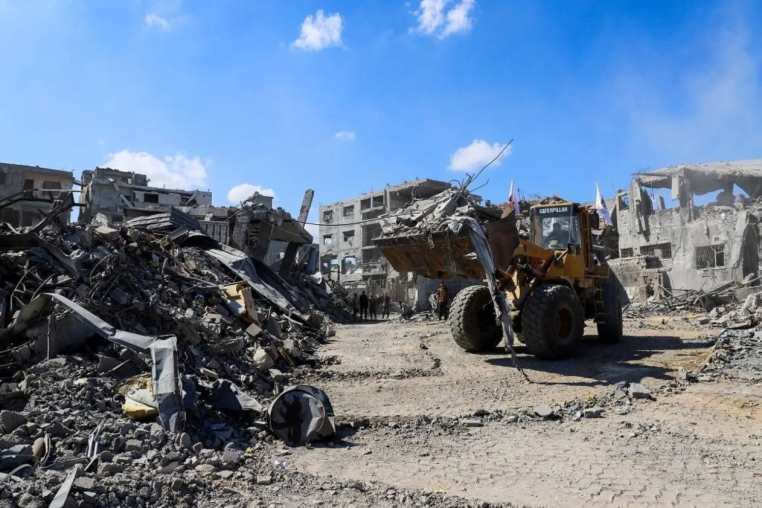 Heavy machinery removes debris from a street, amid a ceasefire between Israel and Hamas, in Gaza City, October 14, 2025. (Reuters)