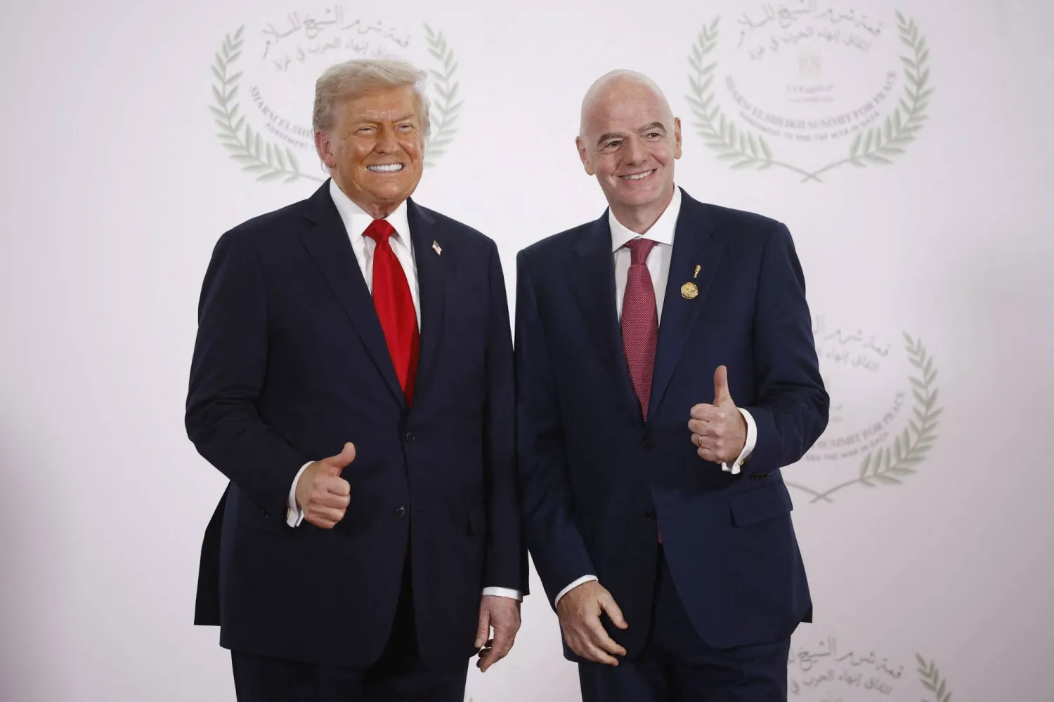 FIFA President Gianni Infantino (R) and US President Donald Trump pose during a summit on Gaza in Sharm El-Sheikh on October 13, 2025. (AFP)