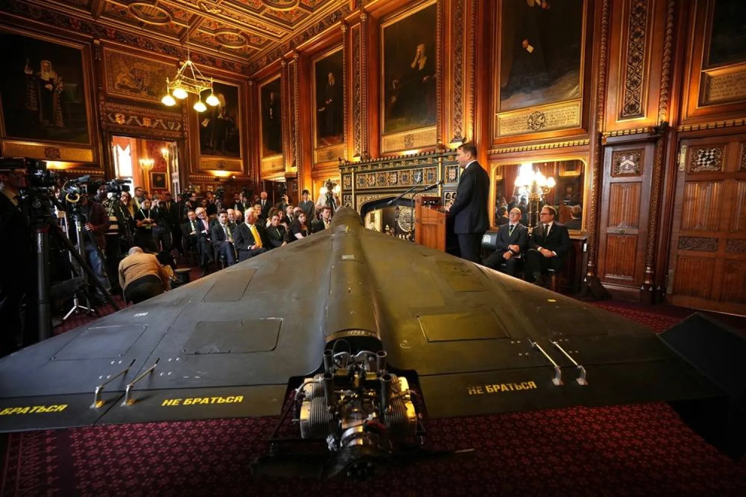 Foreign Minister of Poland, Radek Sikorski speaks next to an Iranian Shahed-136 attack drone, acquired from Ukraine by United Against Nuclear Iran (UANI), at a press conference in Parliament in London, Tuesday, Oct. 14, 2025. (AP) 