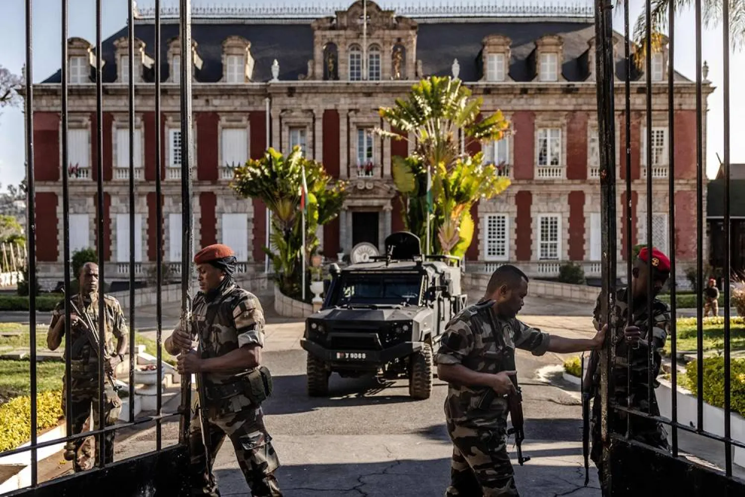 Members of the Madagascar CAPSAT military open the gates of the presidential palace in Antananarivo on October 14, 2025 before Colonel Michael Randrianirina (C), head of the CAPSAT military unit, announced that they will take power in the country. (AFP)