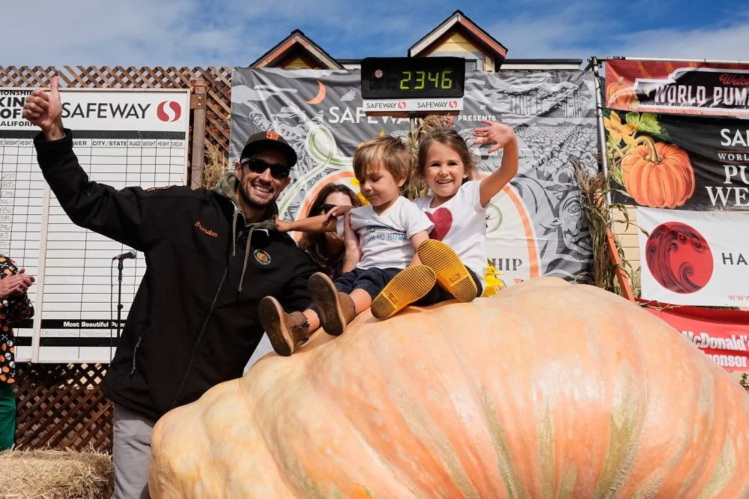 From left, Brandon Dawson celebrates with his children Roman and Ayla after winning the Safeway 52nd annual World Championship Pumpkin Weigh-Off in Half Moon Bay, Calif., Monday, Oct. 13, 2025. (AP Photo/Godofredo A. Vásquez)