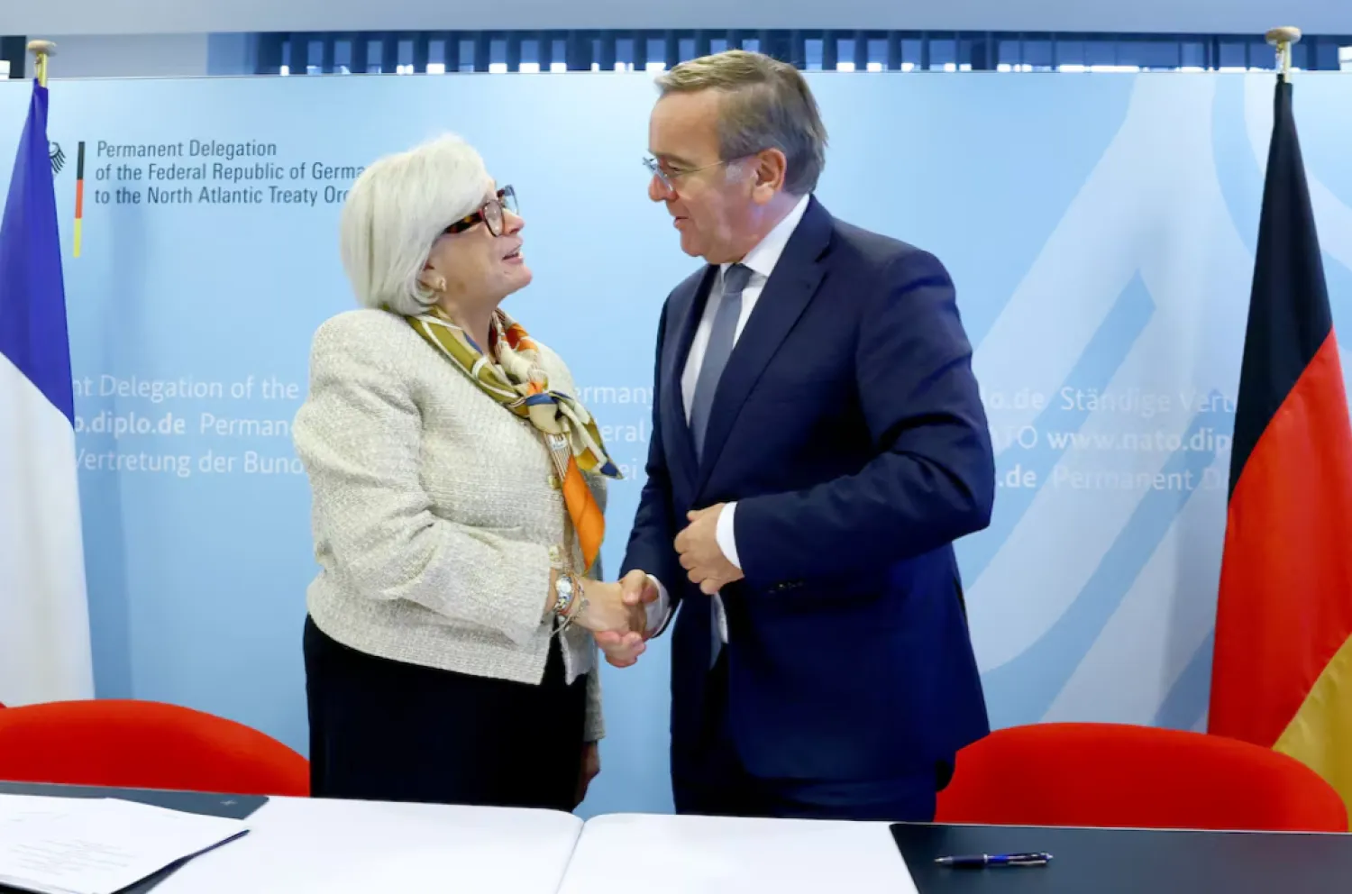 French Defense Minister Catherine Vautrin and German Defense Minister Boris Pistorius shake hands as they sign an implementation agreement for a satellite-based early warning system during a meeting of NATO Defense Ministers at the Alliance headquarters in Brussels, Belgium October 15, 2025. REUTERS/Yves Herman 