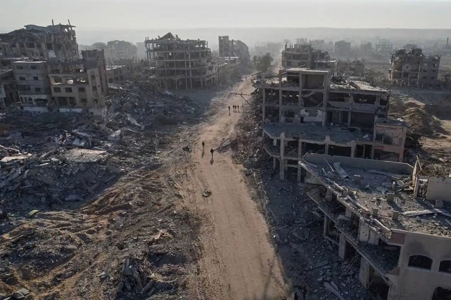  This frame grab from a drone video shoot on Saturday, Oct. 11, 2025, shows Palestinians walking surrounded by destroyed buildings in Gaza City, in the northern Gaza Strip. (AP)