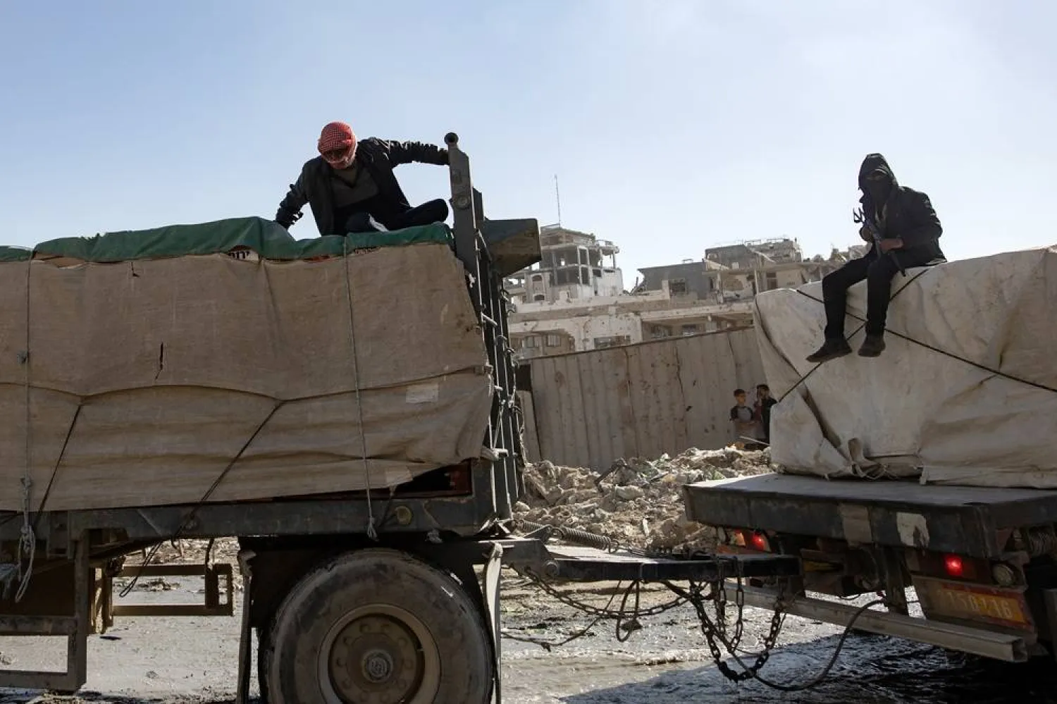 Trucks carrying aid provided by the World Food Program (WFP) drive in Khan Younis in the southern Gaza Strip, 15 October 2025. (EPA)