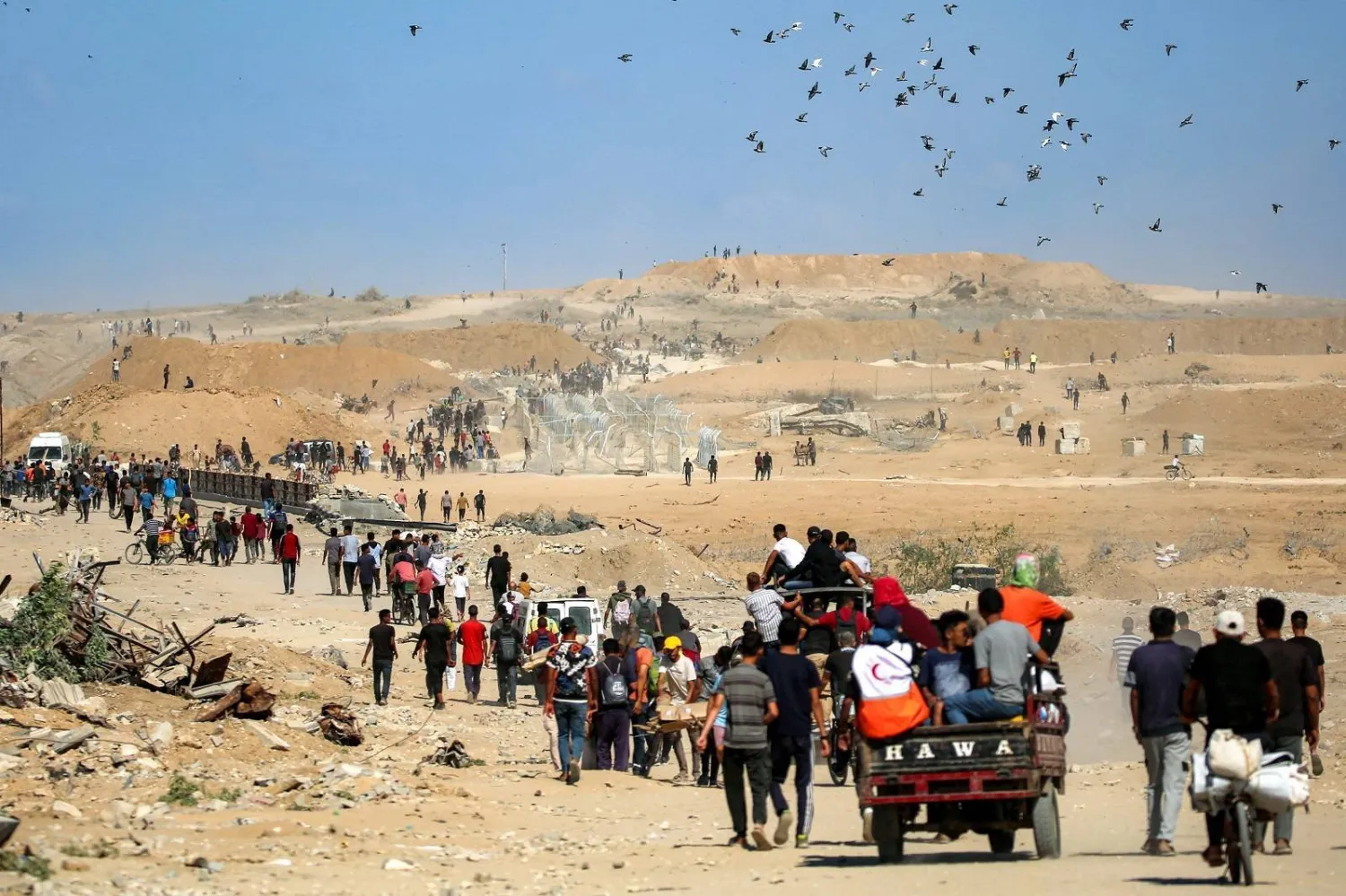 Palestinians walk through the so-called “Netzarim Corridor” near Nuseirat in central Gaza (AFP)