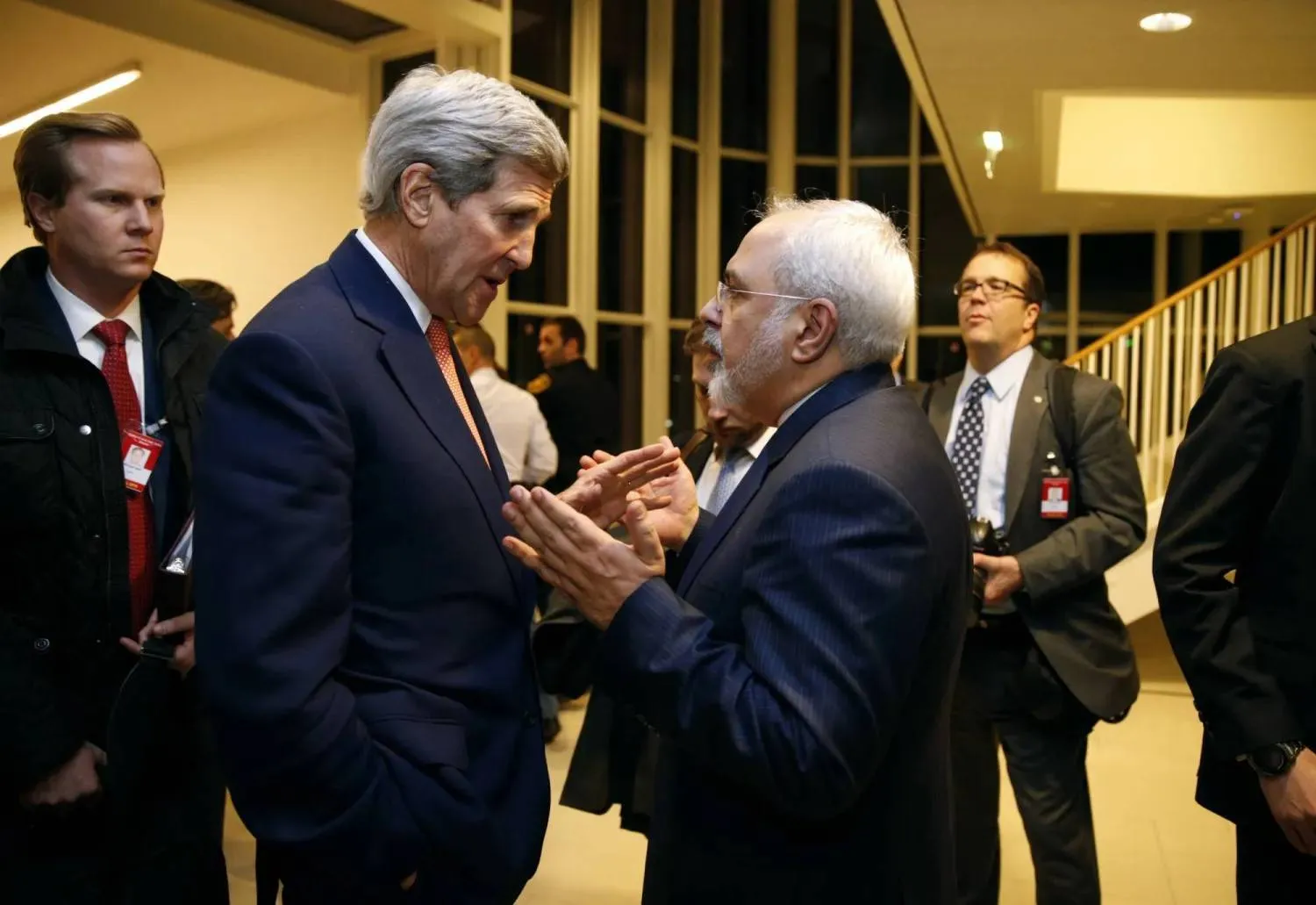 In this January 16, 2016 file photo, then-secretary of state John Kerry talks with Iranian Foreign Minister Mohammad Javad Zarif in Vienna, after the International Atomic Energy Agency (IAEA) verified that Iran has met all conditions under the nuclear deal. (Kevin Lamarque/Pool via AP, File) 