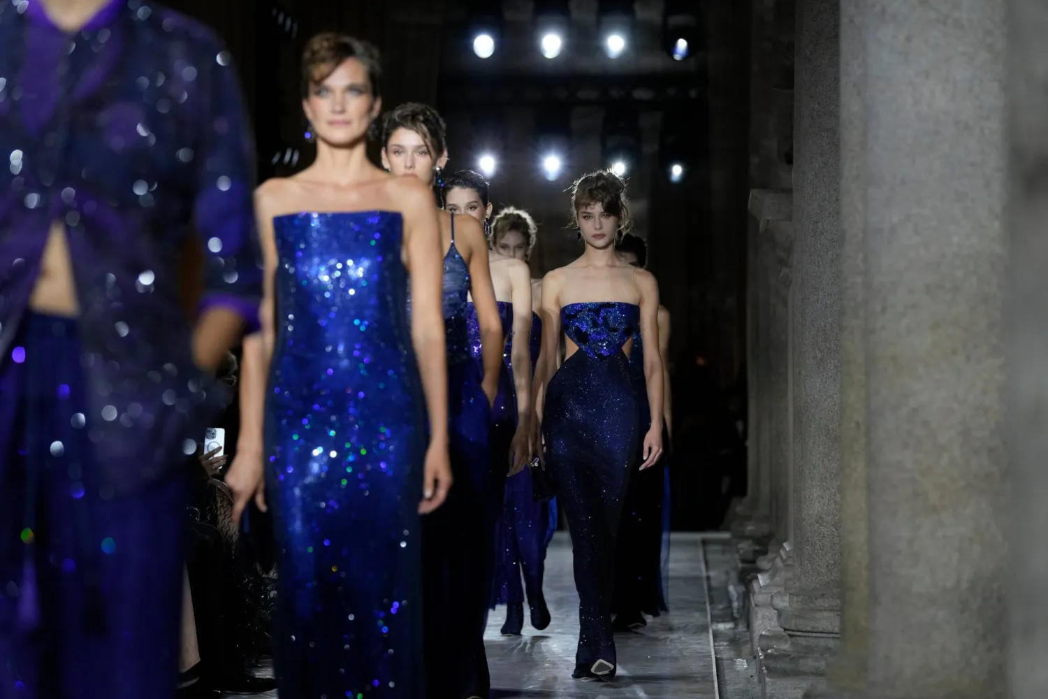 Models wear creations as part of the Giorgio Armani Spring/Summer 2026 collection show in Milan, Italy, Sunday, Sept. 28, 2025. (AP Photo/Luca Bruno)