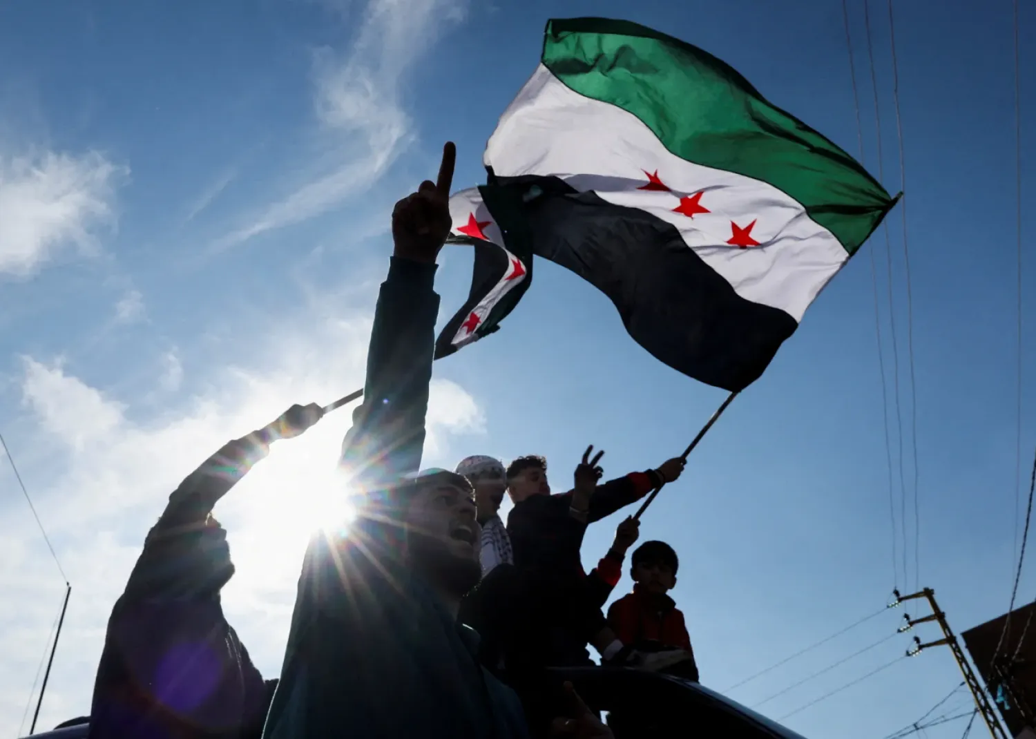 A person waves a Syrian opposition flag at the Masnaa border crossing between Lebanon and Syria, after the announcement of President Bashar al-Assad’s ousting.Photograph by Amr Abdallah Dalsh / Reuters

