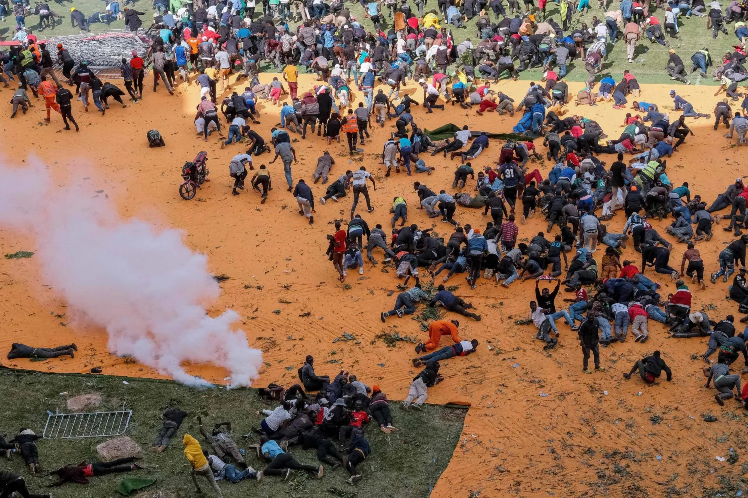 مؤيدو رئيس الوزراء الكيني السابق رايلا أودينغا ينبطحون ويهربون بعد إطلاق قوات الأمن النار وإلقاء عبوات الغاز المسيل للدموع في نيروبي لتفريقهم (أ.ف.ب)