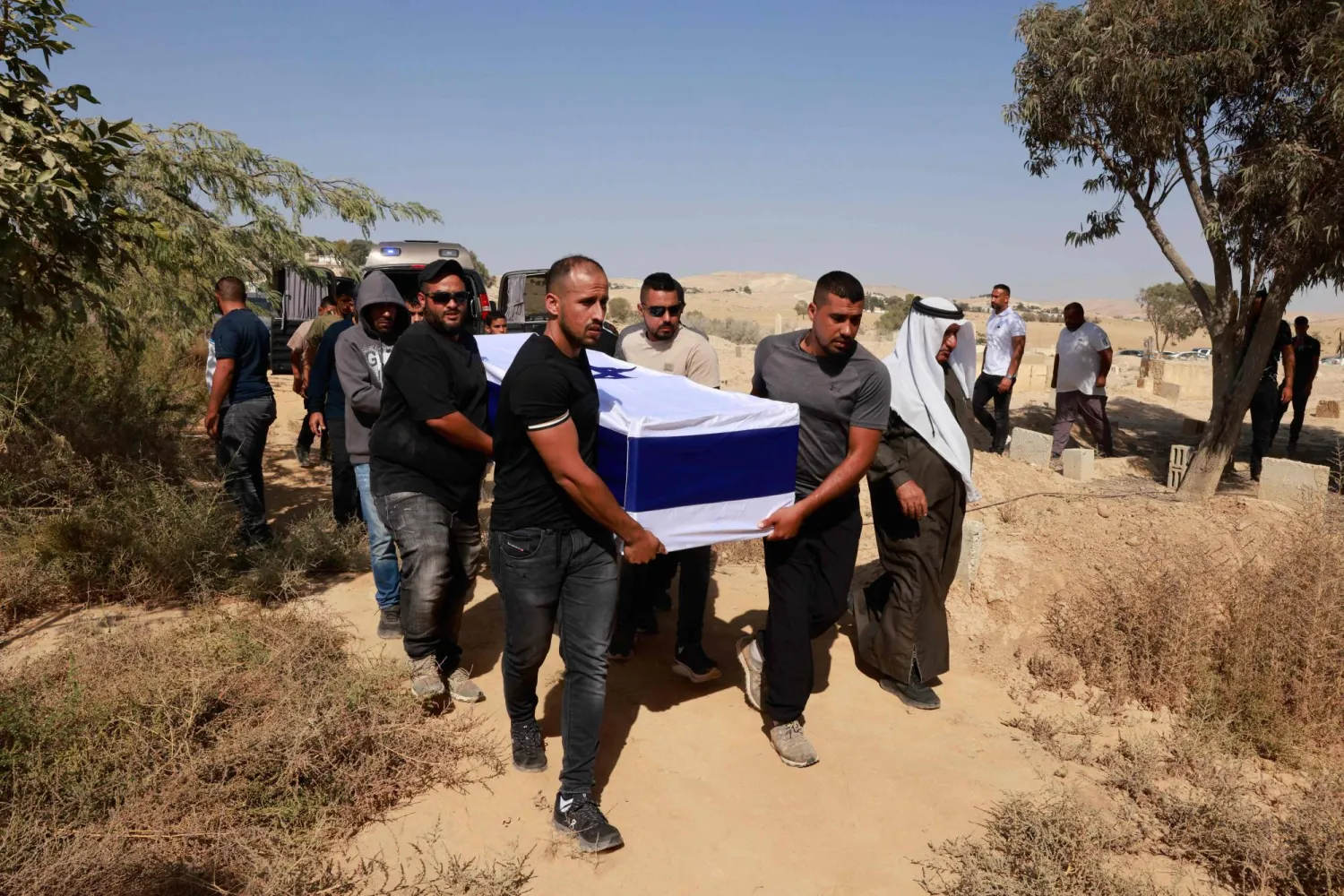 Relatives and friends of Israeli soldier Mohammad Alatrash, a sergeant major in the Israeli military's Bedouin Trackers Unit who was killed in combat during Hamas' October 7, 2023 attack on Israel, carry his coffin during his funeral near Beersheba, on October 16, 2025. (Photo by Menahem Kahana / AFP)