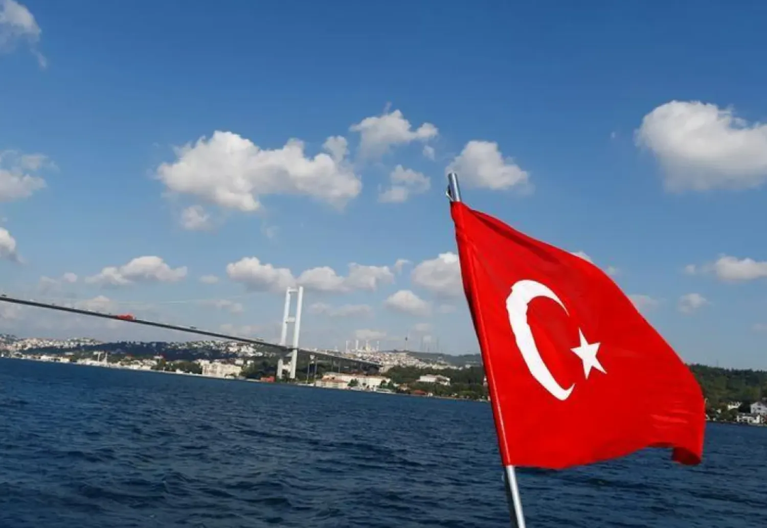 A Turkish flag is pictured on a boat with the Bosphorus bridge in the background in Istanbul, Turkey, August 6, 2016. REUTERS/Osman Orsal
