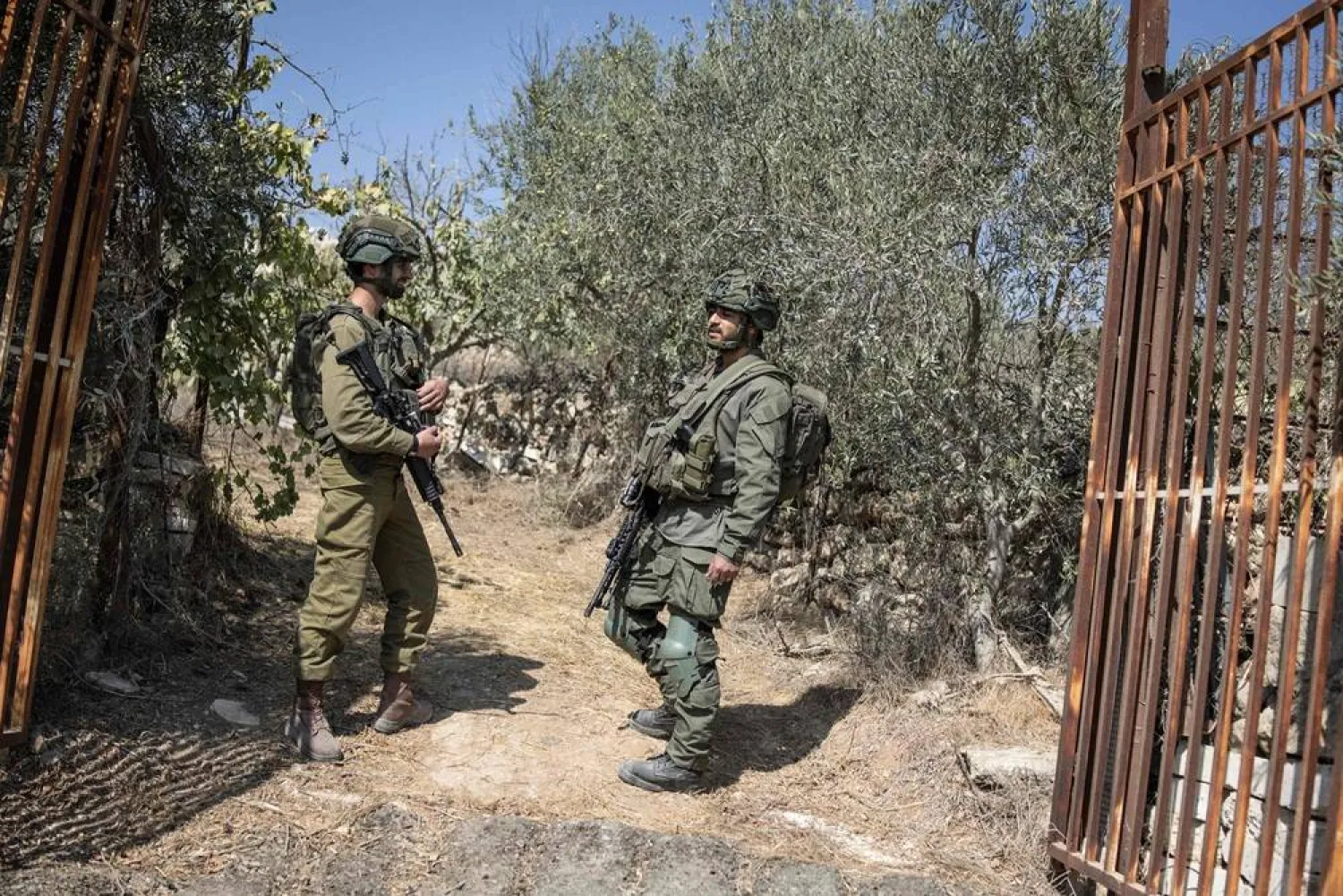 Israeli soldiers block the entrance to a Palestinian olive field near the Israeli settlement of Elazar south of Bethlehem in the occupied West Bank on October 17, 2025. (AFP)