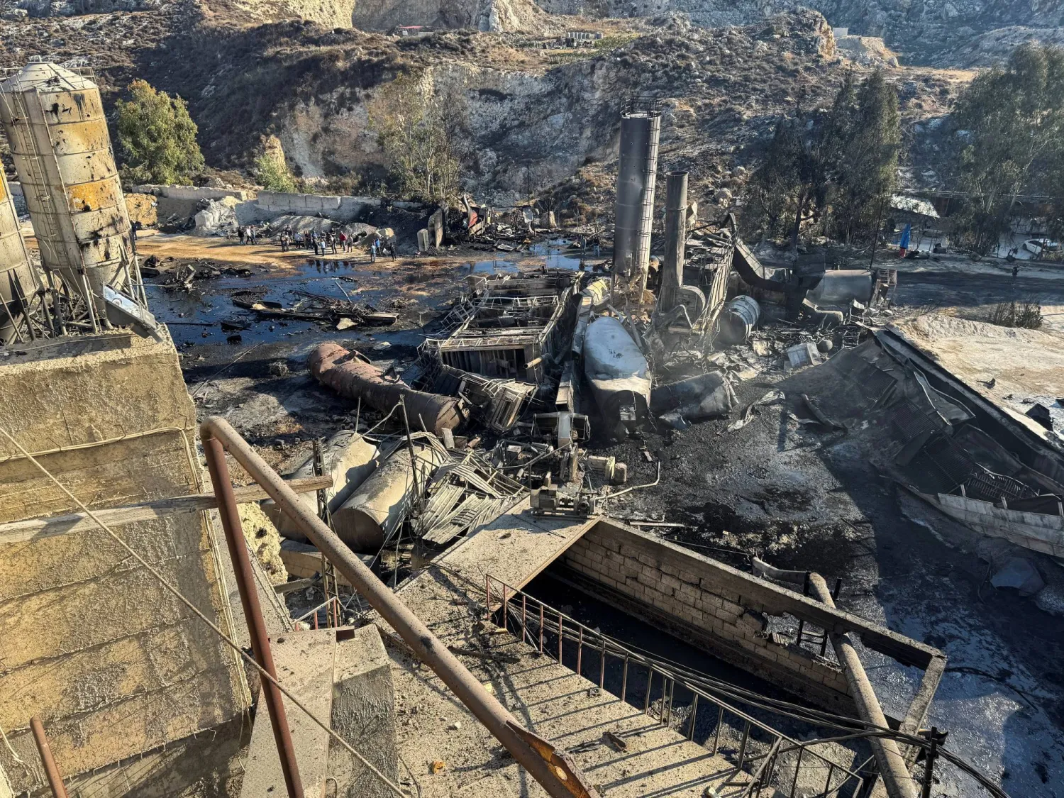 Reuters photo: Lebanese residents inspect a cement factory hit by Israeli airstrikes on Thursday night.