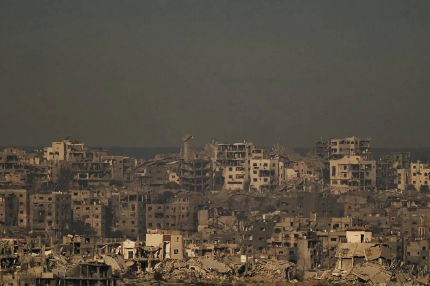  Buildings that were destroyed during the Israeli ground and air operations stand in the northern Gaza Strip during the sunrise, as seen from southern Israel, Friday, Oct. 17, 2025. (AP) 