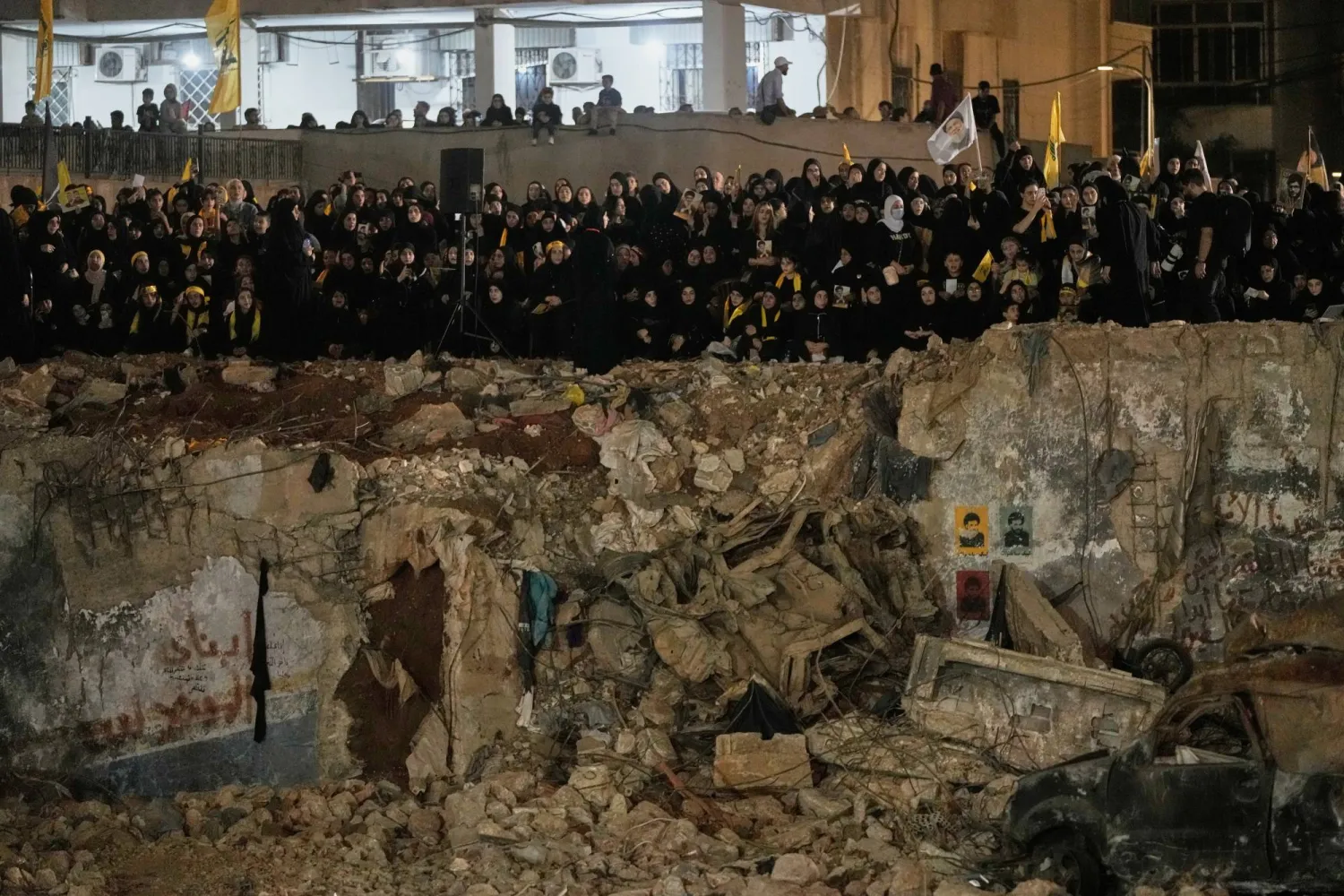 People gather at the site where Hezbollah leader Hassan Nasrallah was killed in Israeli airstrikes on Sept. 27, 2024, a day before the first anniversary of his death, in the Haret Hreik suburb south of Beirut, Lebanon, Friday, Sept. 26, 2025. (AP Photo/Hassan Ammar)