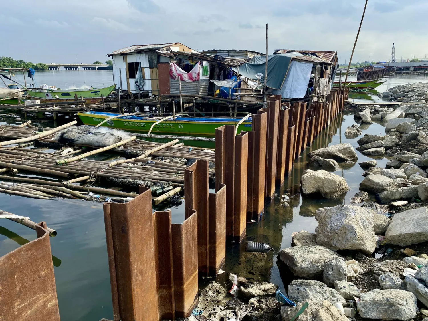 Shanties and fishing boats sit next to an unfinished flood control dike along a coastline in Bacoor City, Cavite province, Philippines, 18 October 2025. EPA/FRANCIS R. MALASIG