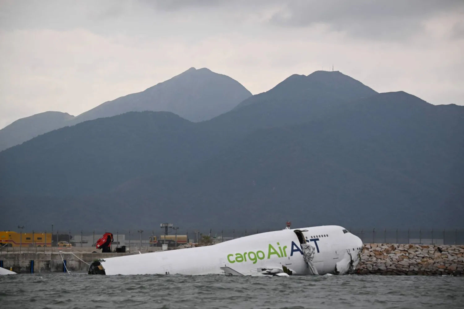 An ACT Airlines Boeing 747-400 cargo aircraft is seen in the water on the north runway of Hong Kong's international airport on October 20, 2025. (Photo by Peter PARKS / AFP)