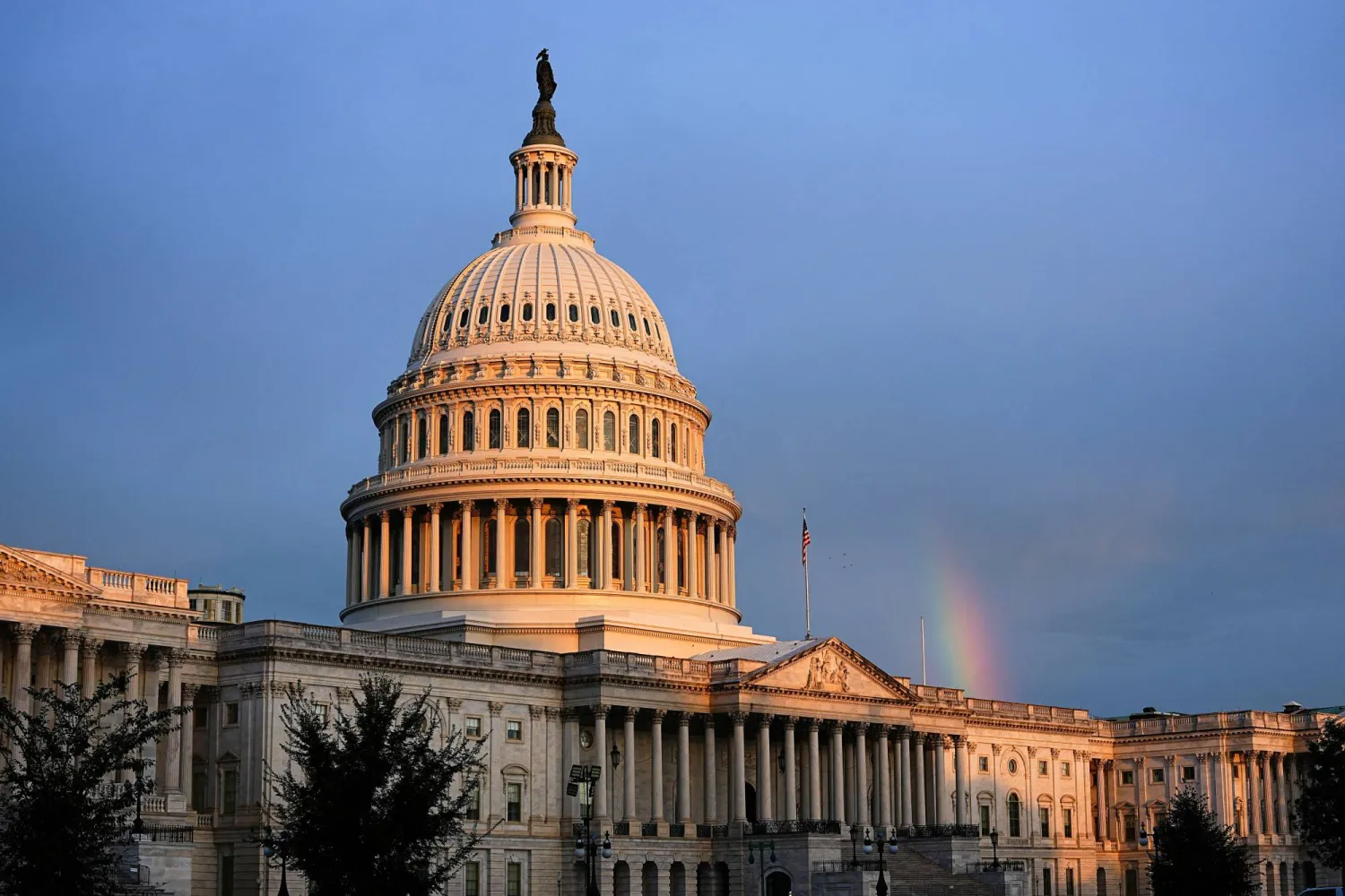A rainbow is visible in the clouds behind the Capitol Building, weeks into the continuing US government shutdown on Capitol Hill in Washington, D.C., US, October 18, 2025. REUTERS/Aaron Schwartz