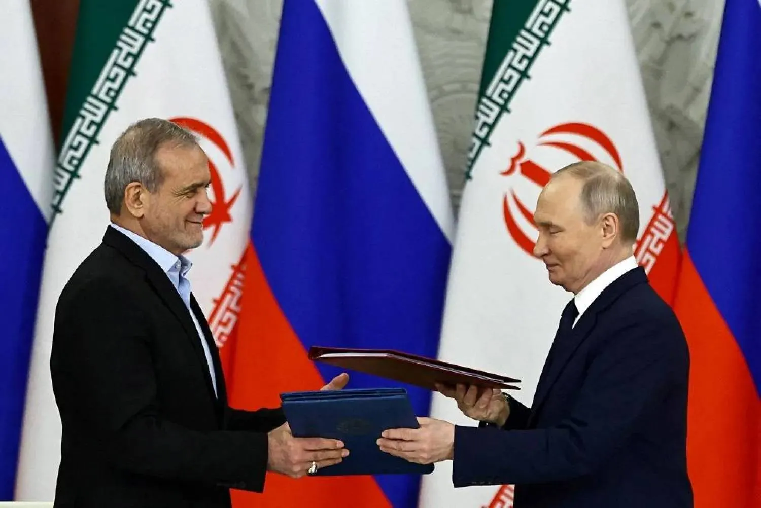 FILE PHOTO: Russian President Vladimir Putin and Iranian President Masoud Pezeshkian attend a documents signing ceremony in Moscow, Russia January 17, 2025. (Reuters)
