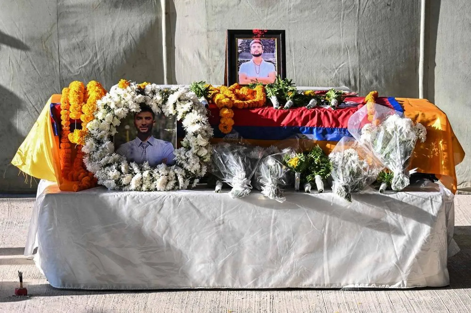 Flowers are placed over the coffin of Bipin Joshi, a deceased Nepali student who was killed while being held hostage in Gaza, at the Tribhuvan International Airport in Kathmandu on October 20, 2025. (AFP) 