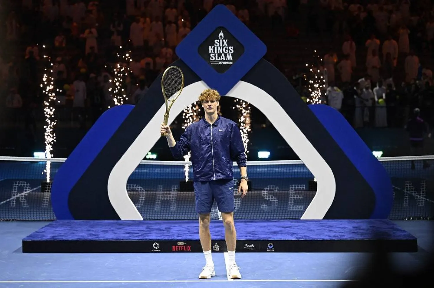 Tennis - Six Kings Slam - ANB Arena, Riyadh, Saudi Arabia - October 18, 2025 Italy's Jannik Sinner celebrates with a racket after winning the final against Spain's Carlos Alcaraz. (Reuters)