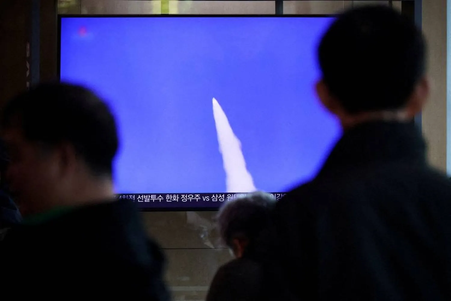 People watch a TV broadcasting a news report on North Korea firing short-range ballistic missiles, at a railway station in Seoul, South Korea, October 22, 2025. (Reuters)