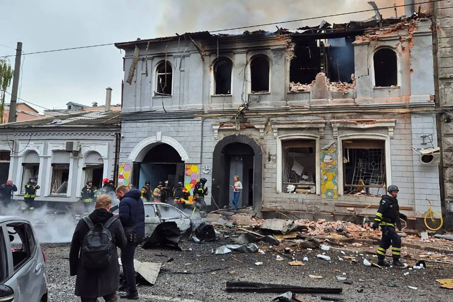 In this handout photograph taken and released by the Ukrainian Emergency Service on October 22, 2025, Ukrainian law enforcement officers work at the site of a drone attack that hit a kindergarten in Kharkiv, amid the Russian invasion of Ukraine. (Handout / Ukrainian Emergency Service / AFP)