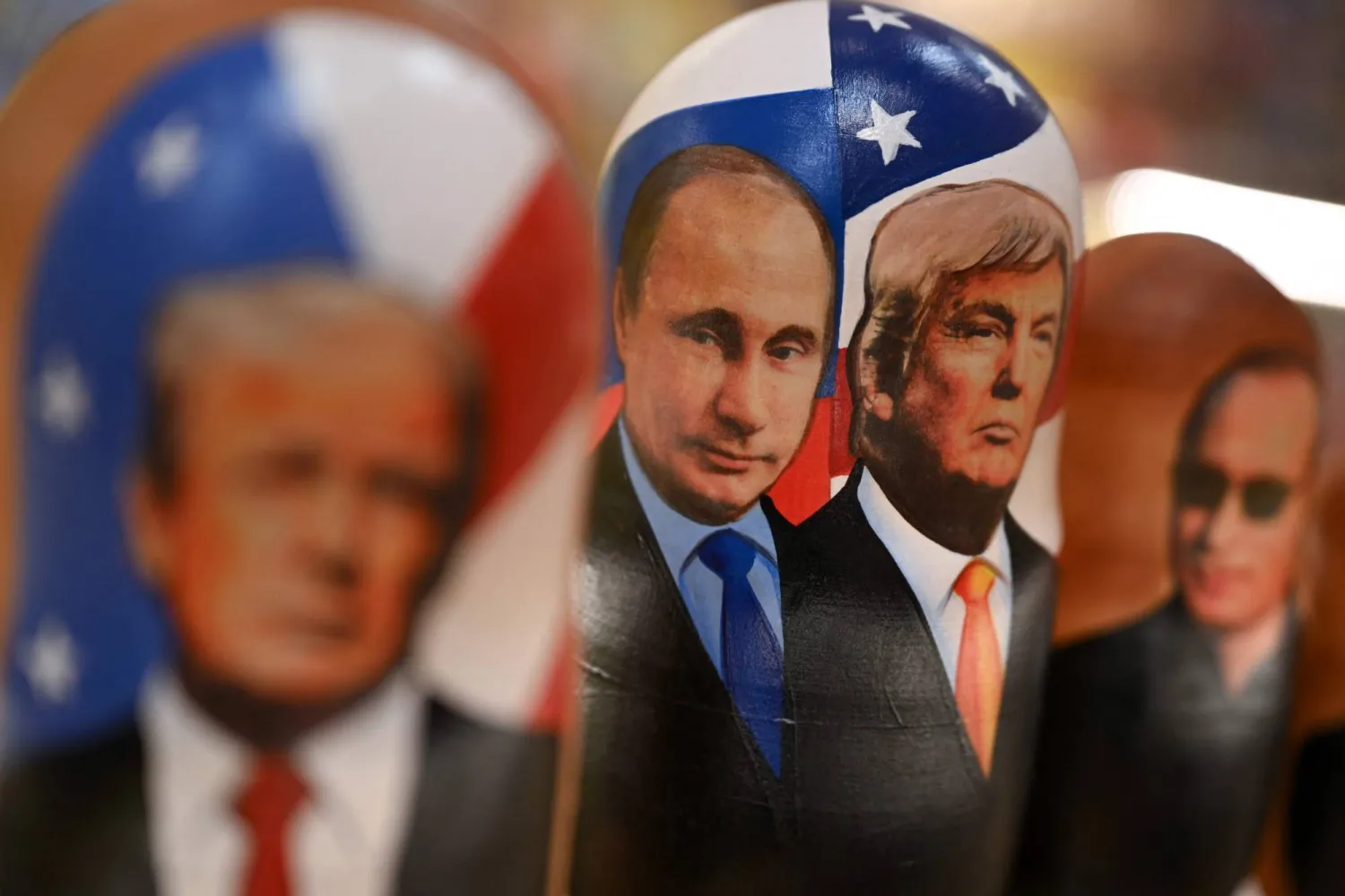 Traditional Russian wooden nesting dolls, Matryoshka dolls, depicting Russian President Vladimir Putin and US President Donald Trump are displayed for sale at a gift shop on the touristic Arbat street in downtown Moscow on October 21, 2025. (AFP) 