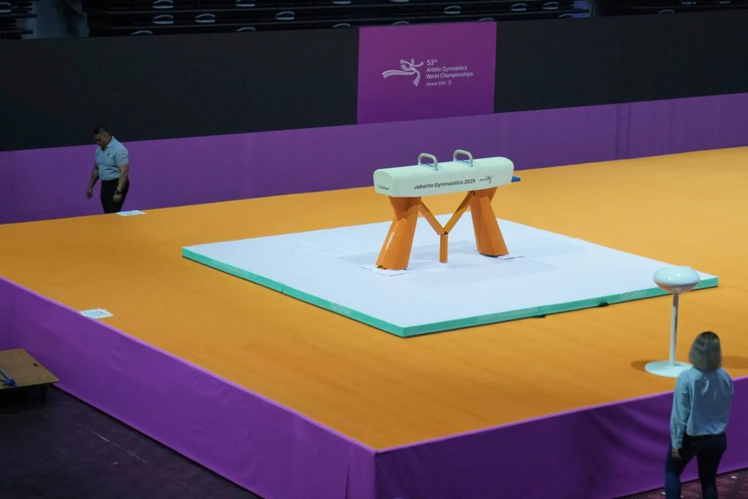 A security guard walks past a pommel horse at the venue prepared for the Artisitic Gymnastics World Championships at Indonesia Arena in Jakarta, Indonesia, Friday, Oct. 10, 2025. (AP Photo/Dita Alangkara) 