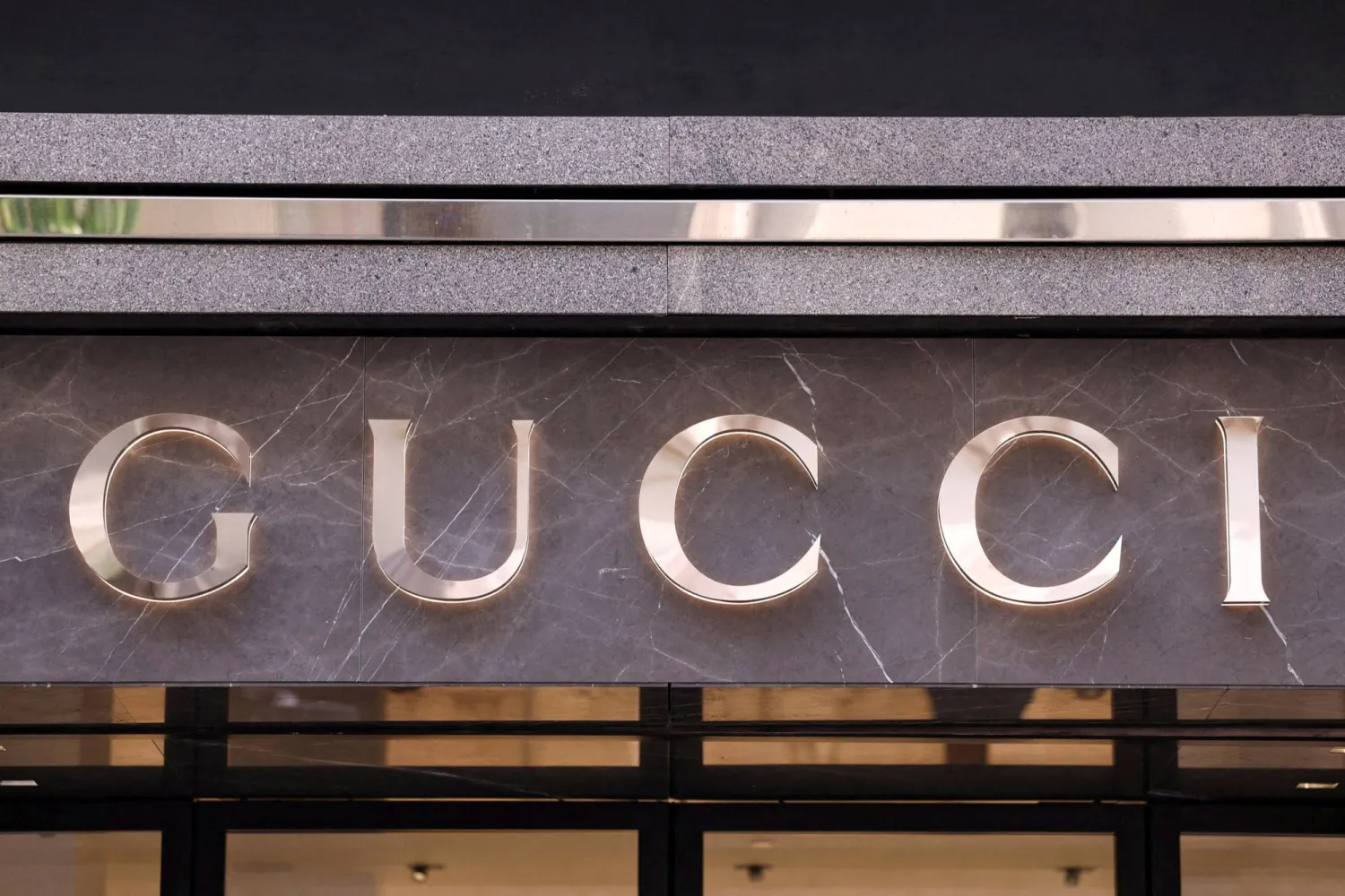 FILE PHOTO: The logo of fashion house Gucci is seen outside a shop in Milan, Italy, April 8, 2024. REUTERS/Claudia Greco/File Photo