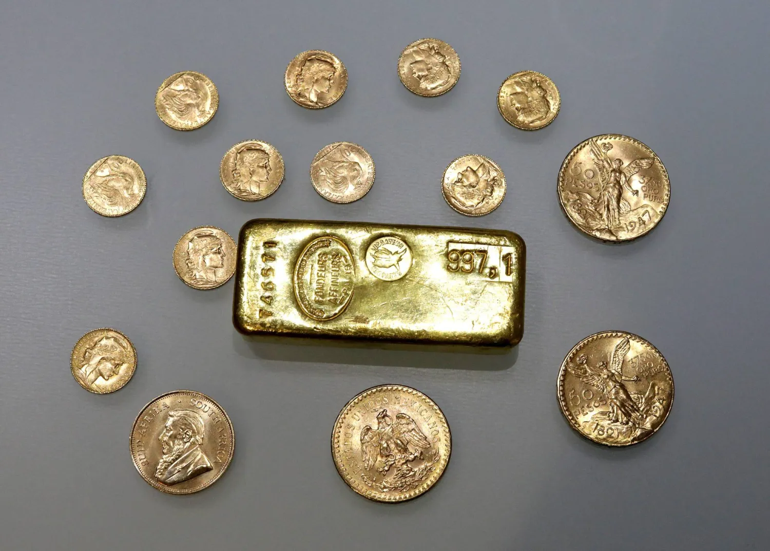 FILE PHOTO: A gold ingot and gold coins are seen in this illustration picture taken November 17, 2017. REUTERS/Eric Gaillard/Illustration/File Photo