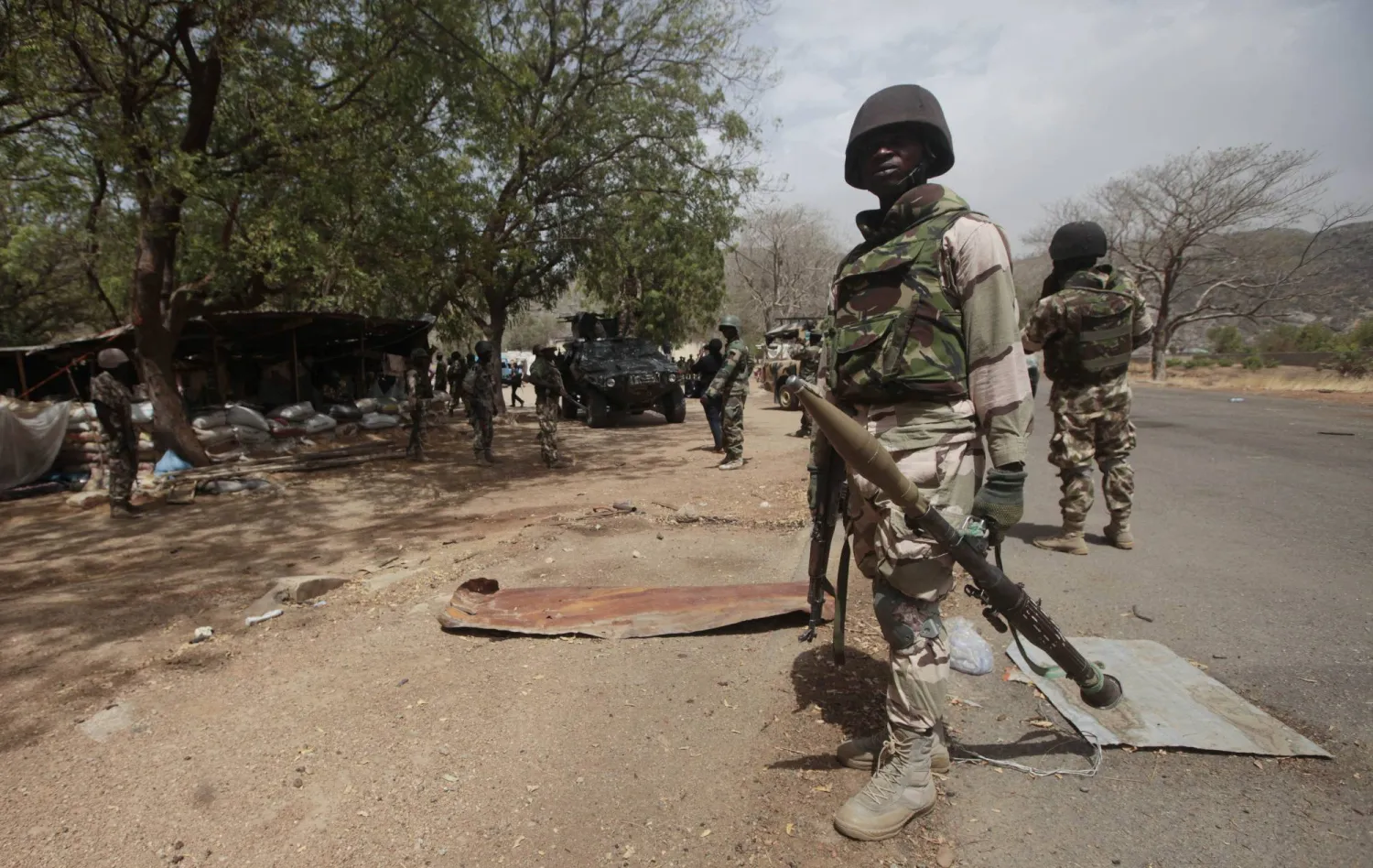 FILE - Nigerian soldiers man a checkpoint in Gwoza, Nigeria, Wednesday April 8, 2015. (AP Photo/Lekan Oyekanmi, File)