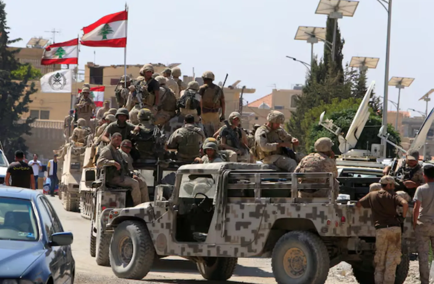 Lebanese army soldiers are seen on their military vehicles in the town of Ras Baalbek, Lebanon August 21, 2017. REUTERS/ Ali Hashisho