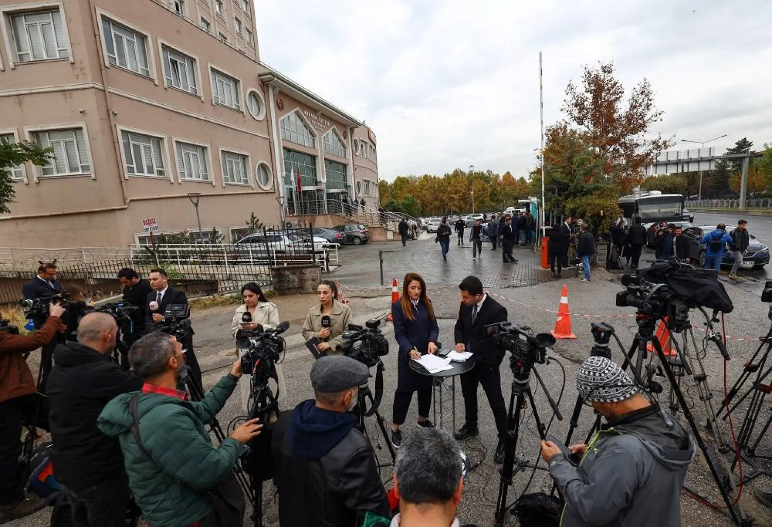 Members of the media report outside a courthouse on the day a Turkish court is expected to announce a verdict in a case seeking the annulment of the main opposition Republican People's Party (CHP) congress in 2023 and the ouster of its leader, Ozgur Ozel, in Ankara, Türkiye, October 24, 2025. (Reuters) 