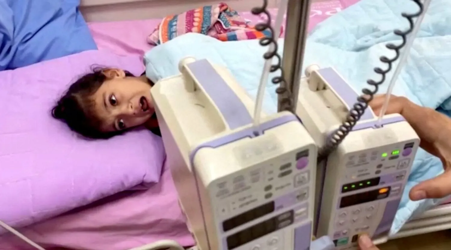 A Palestinian girl cancer patient lies on a bed in the cancer unit at Rantisi hospital, which according to doctors, is running out of supplies, putting dozens of patients at risk, amid the ongoing conflict between Israel and Palestinian Islamist group Hamas, in this still image taken from a video, in Gaza City November 7, 2023. REUTERS TV/via REUTERS 