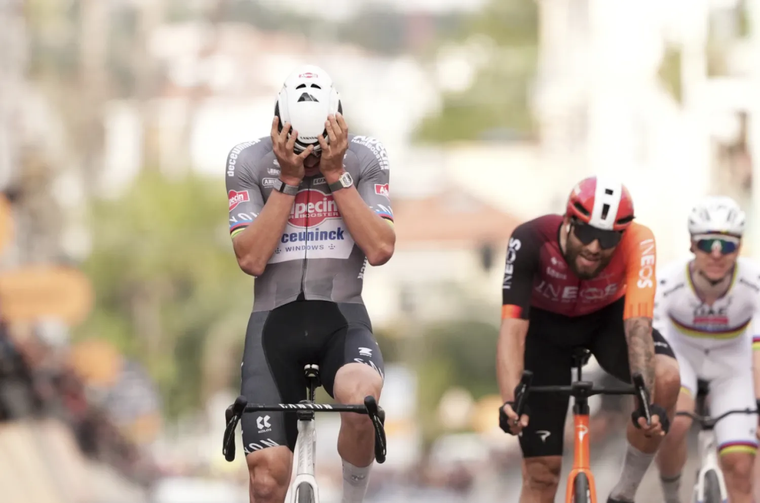 Mathieu van der Poel reacts as he crosses the finish line in first place, with Filippo Ganna on second place, center, and Tadej Pogacar, right, on third place of the men's elite race of the Milano-Sanremo one day cycling race (289 km) from Pavia, in Sanremo, Italy, Saturday March 22, 2025. (Massimo Paolone/LaPresse via AP)