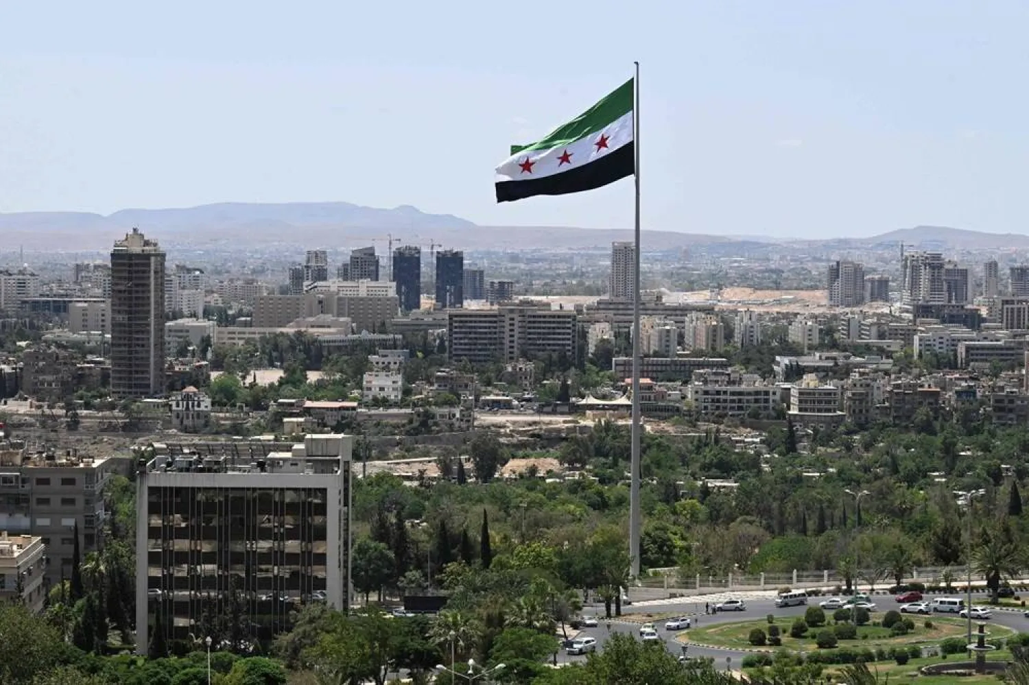 A large Syrian flag flutters above Tishreen Park, Damascus, Syria, June 4, 2025. (AFP)