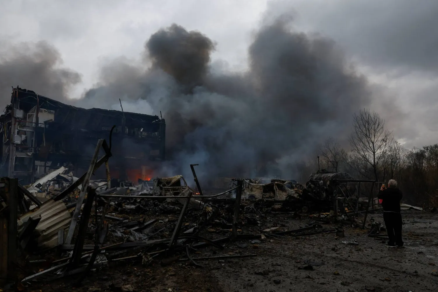 A resident takes a picture of the site of food warehouses hit by an overnight Russian missile strike, amid Russia’s attack on Ukraine, in Kyiv, Ukraine October 25, 2025. REUTERS/Valentyn Ogirenko