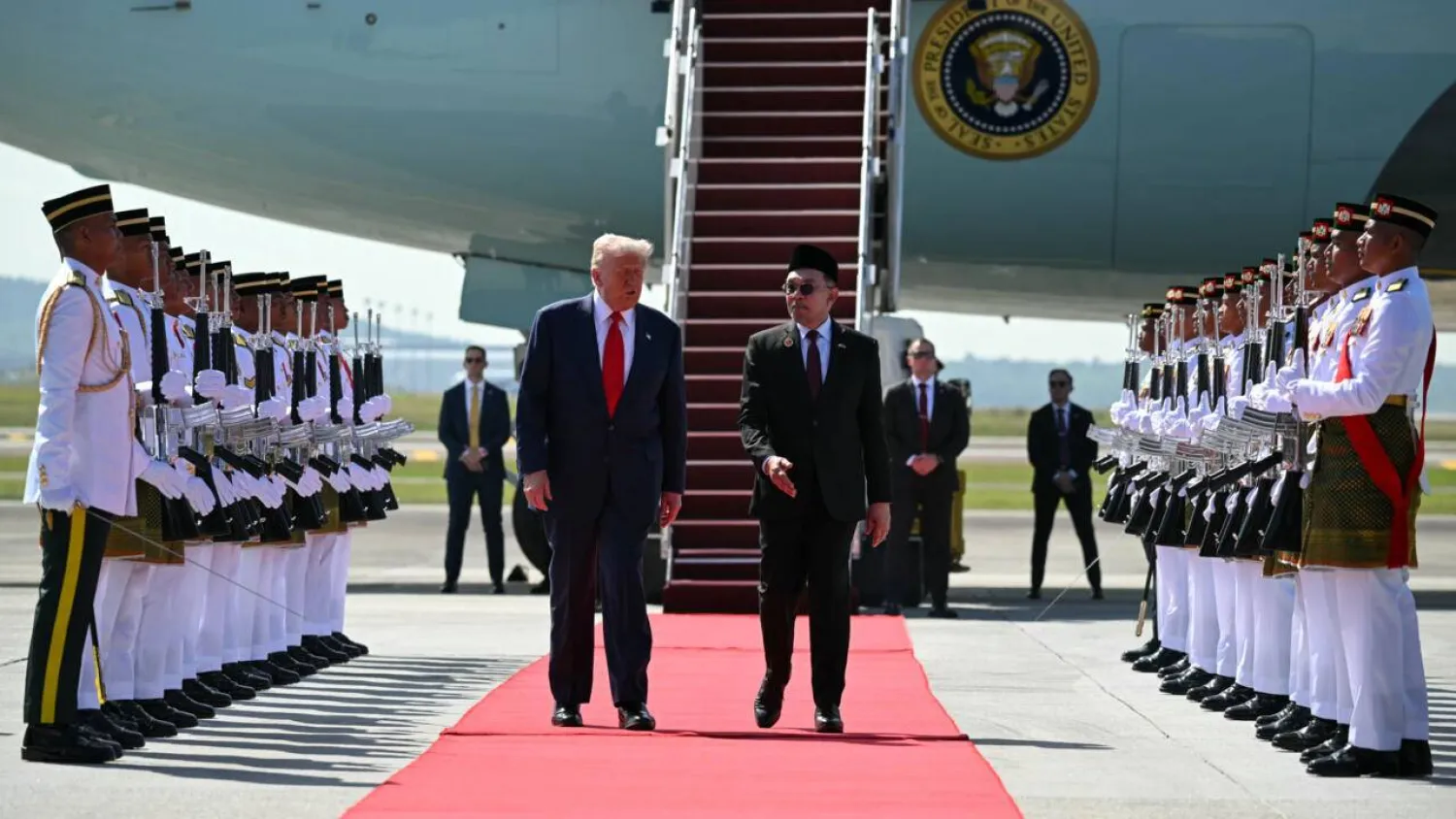 US President Donald Trump with Malaysia's Prime Minister Anwar Ibrahim at Kuala Lumpur International Airport. ANDREW CABALLERO-REYNOLDS / AFP
