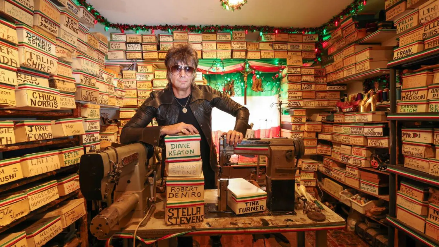 Shoemaker Chris Francis poses with boxes containing the carved molds of celebrities' feet made by Pasquale Di Fabrizio, who made shoes for Hollywood stars for decades. VALERIE MACON / AFP
