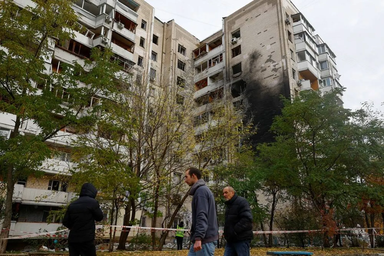 Residents walk in front of an apartment building damaged during an overnight Russian drone strike, amid Russia's attack on Ukraine, in Kyiv, Ukraine October 26, 2025. (Reuters)