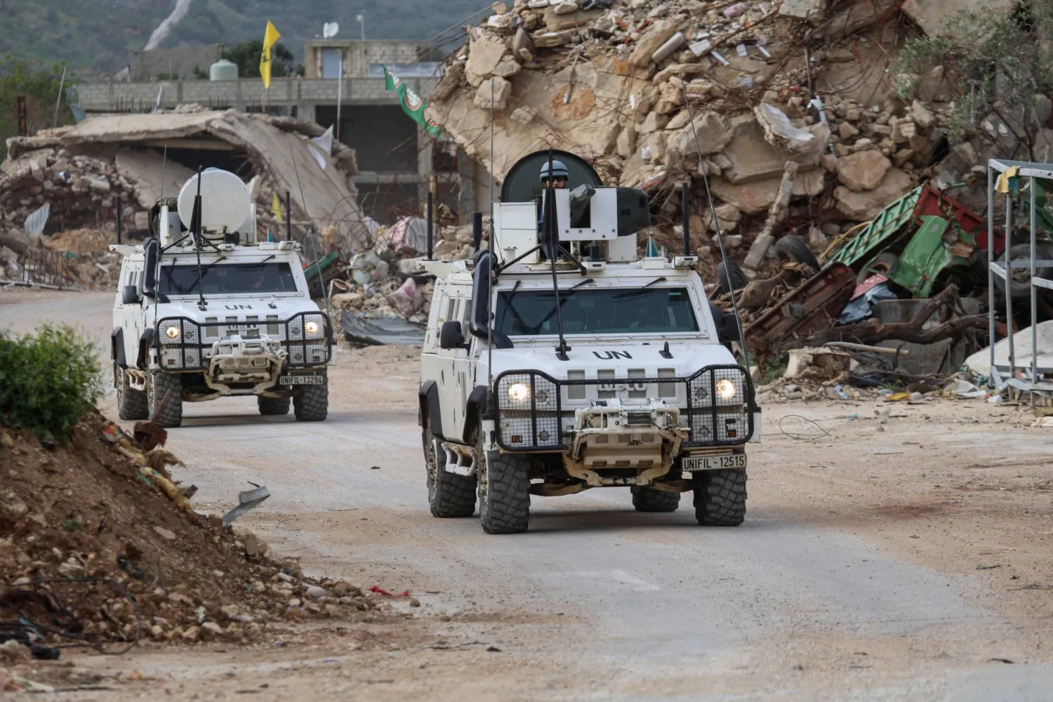 (FILES) United Nations peacekeepers drive in vehicles of the UN Interim Force in Lebanon (UNIFIL) past destroyed buildings while patrolling in Lebanon's southern village of Kfar Kila close to the border with Israel on April 6, 2025. (Photo by Rabih DAHER / AFP)